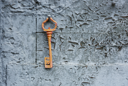Old key on wooden antique door close-upの写真素材