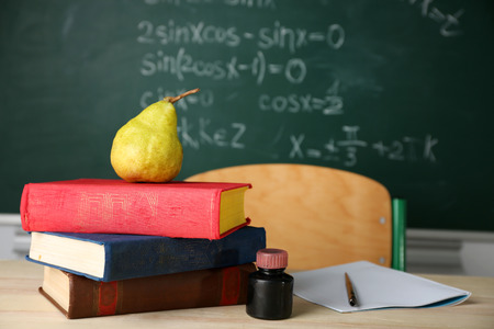Teachers workplace  on blackboard backgroundの写真素材