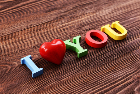 Inscription I LOVE YOU made of colorful letters on wooden backgroundの写真素材