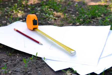 Building roulette and pencil on white sheets of paper, outdoorsの写真素材