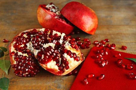 Pomegranate seeds on wooden table, closeupの写真素材