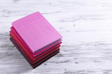 Stack of books on wooden backgroundの写真素材