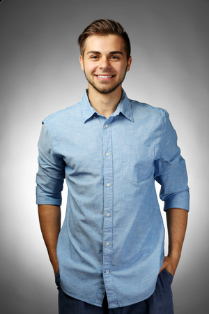 Handsome man on gray backgroundの写真素材