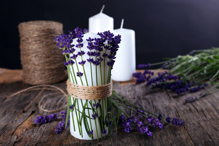 Candle with lavender flowers on table close upの写真素材