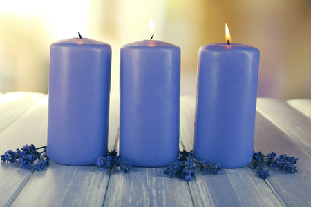 Candles with lavender flowers on bright backgroundの写真素材