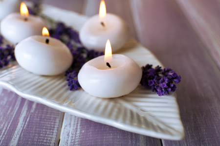 Candles with lavender flowers on table close upの写真素材