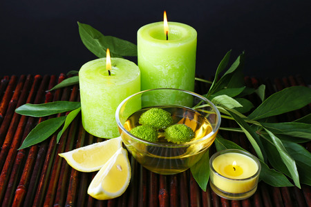 Spa still life in green color on bamboo mat on dark backgroundの写真素材