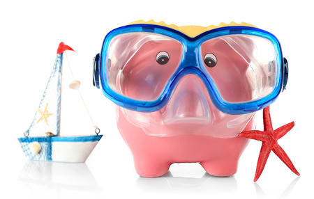 Piggy bank with mask for diving and nautilus isolated on whiteの写真素材