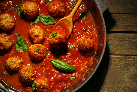 Pan with meat balls in tomato sauce, on wooden backgroundの写真素材