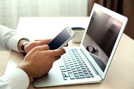 Man using mobile phone in officeの写真素材