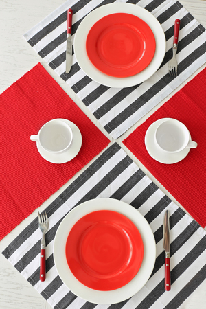 Table setting with red and striped napkinsの写真素材