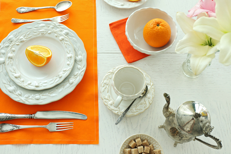 Table setting with orange napkinの写真素材