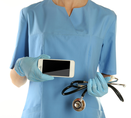 Doctor with stethoscope and smart phone, isolated on whiteの写真素材