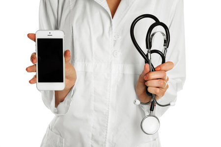 Doctor with stethoscope and smart phone, isolated on whiteの写真素材