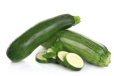 Fresh zucchini with basil isolated on whiteの写真素材