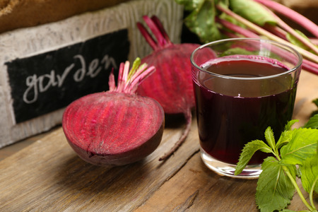 Fresh beet juice on wooden table, closeup