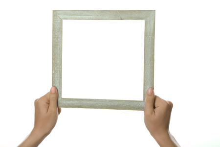 Female hands with wooden frame, isolated on whiteの写真素材