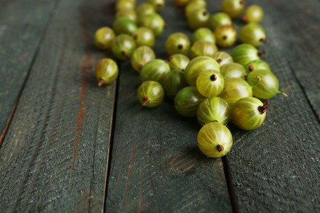 Green gooseberry on wooden backgroundの写真素材