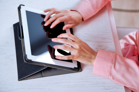 Woman using digital tablet on table close upの写真素材