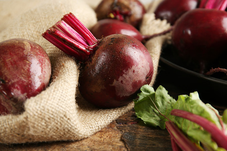 Young beets with leaves on wooden table close upの写真素材