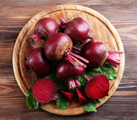 Young beets with leaves on wooden table close upの写真素材