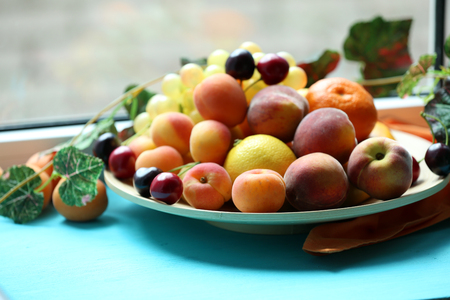 Heap of fresh fruits on windowsillの写真素材