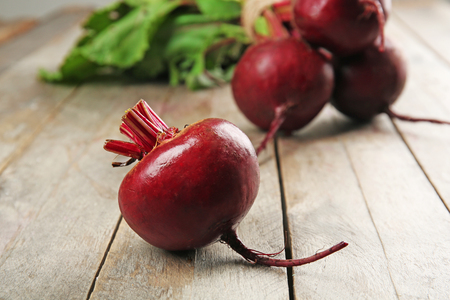 Young beets with leaves on wooden table close upの写真素材