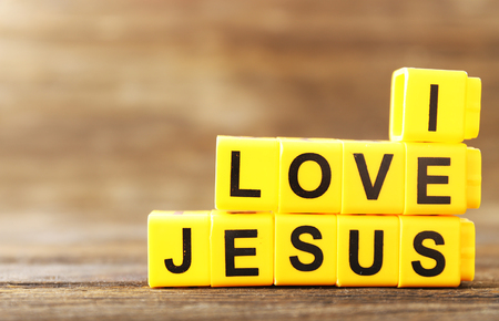 I LOVE JESUS sign illustrated with yellow plastic letters on wooden backgroundの写真素材