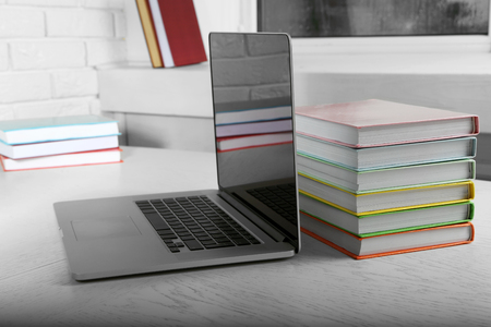 Stack of books with laptop on table close upの写真素材