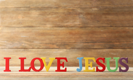 I LOVE JESUS sign illustrated with colorful plastic letters on wooden backgroundの写真素材