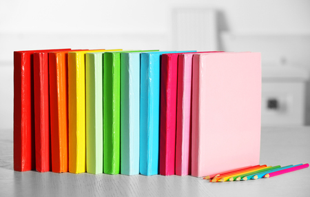 Colorful books and pencil on table in roomの写真素材
