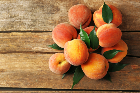 Ripe peaches on wooden backgroundの写真素材