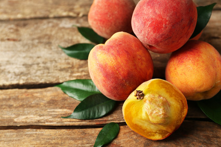 Ripe peaches on wooden backgroundの写真素材