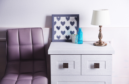 Table lamp on commode in roomの写真素材