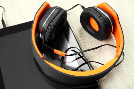 Headphones with tablet on wooden table close upの写真素材