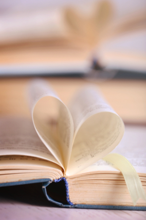 Pages of book curved into heart shape, close upの写真素材