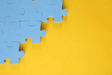 Puzzle pieces on yellow backgroundの写真素材