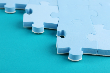 Puzzle pieces on blue backgroundの写真素材