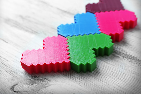 Plastic hearts on wooden background
