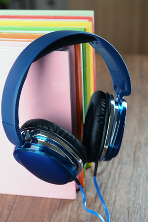 Books and headphones as audio books concept on wooden table, closeupの写真素材