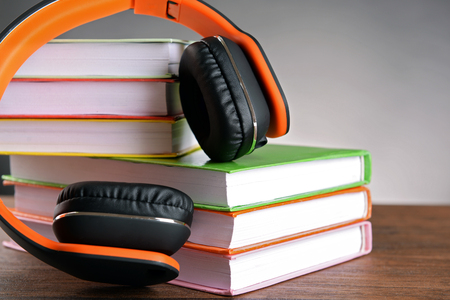 Books and headphones as audio books concept on grey backgroundの写真素材