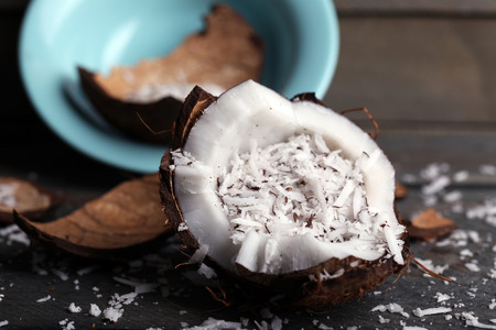 Coconut shavings in coconut on wooden backgroundの写真素材