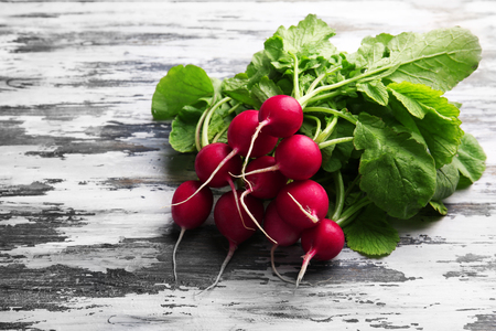 Fresh red radish on wooden backgroundの写真素材