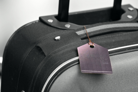 Suitcase with TRAVEL INSURANCE label, closeupの写真素材