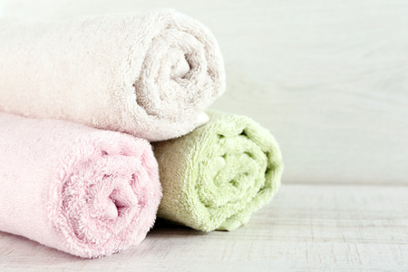 Stack of colorful towels on light backgroundの写真素材