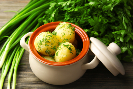 Boiled potatoes with dill in pan on table close upの写真素材