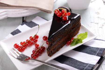 Tasty chocolate cake with berries on table close upの写真素材
