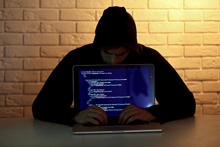 Hacker with laptop の写真素材