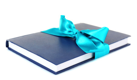 Book wrapped with color ribbon isolated on whiteの写真素材