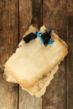 Machine for tattoo with old paper on table close upの写真素材